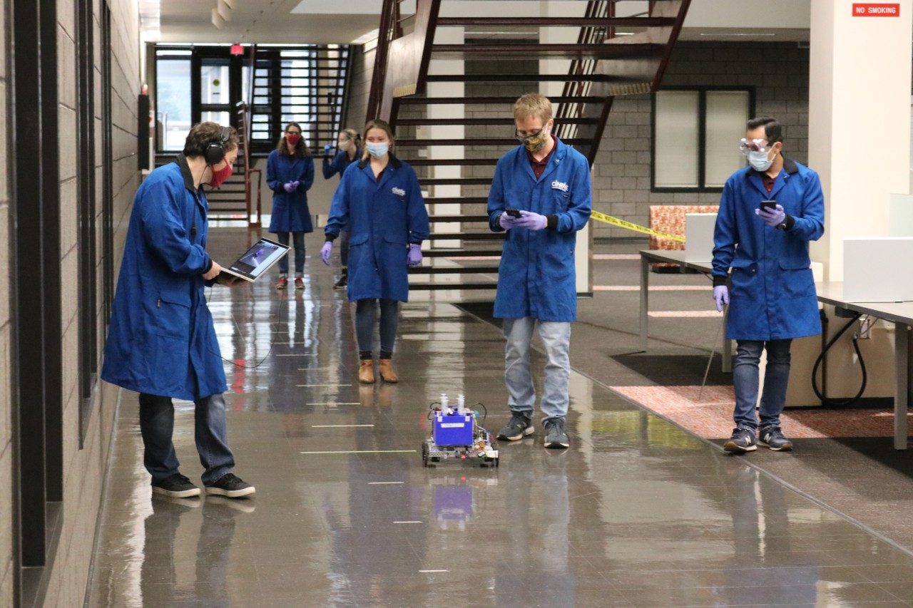 Students from the chemical engineering Chem-E-Car team with their robotic car
